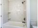 Bathroom with elegant marble tiling around shower and tub, with black hardware at 4932 South Island Dr., North Myrtle Beach, SC 29582