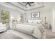 Bright bedroom featuring tray ceilings, large windows, and a stylish furniture arrangement at 4932 South Island Dr., North Myrtle Beach, SC 29582
