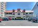 Charming building on pilings with red shutters and covered porch, surrounded by parking at 4932 South Island Dr., North Myrtle Beach, SC 29582