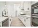 Modern kitchen featuring stainless appliances, a large island and a view to the entry at 4932 South Island Dr., North Myrtle Beach, SC 29582