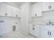 Laundry room with marble countertop and tiled floor, offering a luxurious and functional space at 4932 South Island Dr., North Myrtle Beach, SC 29582
