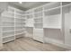 Spacious walk-in closet features custom shelving and drawers, maximizing storage and organization at 4932 South Island Dr., North Myrtle Beach, SC 29582