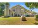 Charming home exterior with lush lawn, beautiful stone accent and well-maintained landscaping at 503 20Th Ave. N # 19-C, North Myrtle Beach, SC 29582