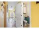 Well-lit hallway leading to the bathroom, with tile flooring and neutral-colored walls at 510 Fairwood Lakes Dr. # 16-I, Myrtle Beach, SC 29588