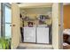 Practical laundry area with a stacked washer and dryer unit and ample storage shelving at 510 Fairwood Lakes Dr. # 16-I, Myrtle Beach, SC 29588