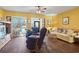 Comfortable living room with hardwood floors, two recliners, and a view into the sunroom at 510 Fairwood Lakes Dr. # 16-I, Myrtle Beach, SC 29588