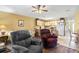 Cozy living room seamlessly connects to the kitchen, with hardwood floors and neutral colored walls at 510 Fairwood Lakes Dr. # 16-I, Myrtle Beach, SC 29588