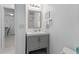 Bright bathroom features a gray vanity with storage and a well-lit mirror at 513 38Th Ave. N # 202, Myrtle Beach, SC 29577