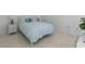 A cozy bedroom setup with a bed, side tables, and blue accents against a white wall at 513 38Th Ave. N # 202, Myrtle Beach, SC 29577