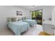Comfortable bedroom with two twin beds, a sliding glass door and modern décor at 513 38Th Ave. N # 202, Myrtle Beach, SC 29577