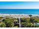 Stunning ocean view with boardwalk and pathways through lush palm trees at 513 38Th Ave. N # 202, Myrtle Beach, SC 29577
