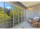 Relaxing screened-in patio with rocking chairs and views of the trees at 513 38Th Ave. N # 202, Myrtle Beach, SC 29577