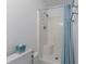 Clean bathroom with shower and a blue shower curtain; essential amenities are present at 513 38Th Ave. N # 202, Myrtle Beach, SC 29577