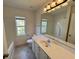 Bright bathroom with a large mirror, vanity, and a window providing natural light at 514 Hay Hill Ln. # C, Myrtle Beach, SC 29579