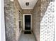 Covered entryway featuring brick walls and a secure black front door at 514 Hay Hill Ln. # C, Myrtle Beach, SC 29579