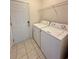 Well-equipped laundry room featuring a washer, dryer, and overhead shelving at 514 Hay Hill Ln. # C, Myrtle Beach, SC 29579