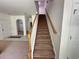 Carpeted staircase with wooden handrail leads to the upper level at 514 Hay Hill Ln. # C, Myrtle Beach, SC 29579