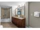 Bathroom featuring double sinks, a large mirror, and a shower-tub combo at 5200 N Ocean Blvd. # 632, Myrtle Beach, SC 29577