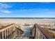 Beautiful beach access with wooden stairs, leading to pristine sands and ocean views under a clear blue sky at 5200 N Ocean Blvd. # 632, Myrtle Beach, SC 29577