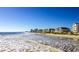 View of beachfront homes along a sandy beach with gentle waves and a clear blue sky at 532 Duvall St., Longs, SC 29568