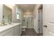 Bright bathroom featuring a large shower with glass doors, a vanity with storage, and modern fixtures at 540 Duvall St., Longs, SC 29568