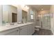Modern bathroom with double sinks, a spacious glass-enclosed shower, and sleek white cabinets at 540 Duvall St., Longs, SC 29568