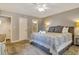 Spacious bedroom featuring a ceiling fan, plush carpeting, and a glimpse of the en-suite bathroom at 5507 N Ocean Blvd. # 105, Myrtle Beach, SC 29577