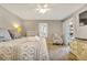 Comfortable bedroom with a ceiling fan, patterned bedding, and a balcony access, designed for relaxation at 5507 N Ocean Blvd. # 105, Myrtle Beach, SC 29577