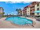 Inviting community pool with lounge chairs and lush landscaping, perfect for relaxation at 5507 N Ocean Blvd. # 105, Myrtle Beach, SC 29577