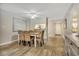Cozy dining room with wood flooring, a ceiling fan, and woven chairs next to the opening to the kitchen at 5507 N Ocean Blvd. # 105, Myrtle Beach, SC 29577