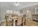 Inviting dining room area with woven chairs and wood flooring, adjacent to the kitchen bar at 5507 N Ocean Blvd. # 105, Myrtle Beach, SC 29577