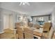 Open-concept living area with a dining table, recliner, and access to a balcony with scenic views at 5507 N Ocean Blvd. # 105, Myrtle Beach, SC 29577
