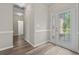 Bright entryway featuring wood-look flooring, decorative glass front door, and neutral walls at 561 Bucks Trail, Longs, SC 29568