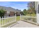 Brick home exterior with a white picket fence and manicured lawn, offering a charming curb appeal at 561 Bucks Trail, Longs, SC 29568