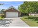 Attached brick garage with a white door and ample driveway space, providing convenient parking at 561 Bucks Trail, Longs, SC 29568