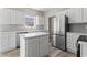 Bright, modern kitchen with white cabinets, stainless steel appliances and central island at 561 Bucks Trail, Longs, SC 29568
