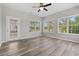 Light and bright living room with luxury vinyl plank flooring, ceiling fan, and outdoor access at 561 Bucks Trail, Longs, SC 29568