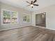 Bright living room featuring a ceiling fan, natural light, and luxury vinyl plank flooring at 561 Bucks Trail, Longs, SC 29568