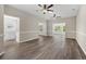 Spacious living room with wood-look flooring, neutral walls, and two ceiling fans at 561 Bucks Trail, Longs, SC 29568