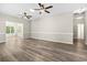 Open living area with wood-look floors, ceiling fans, and a view to the sunroom at 561 Bucks Trail, Longs, SC 29568