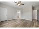 Main bedroom featuring wood-look floors and an ensuite bathroom with a tub at 561 Bucks Trail, Longs, SC 29568