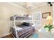 Bunk beds in a bedroom with a ceiling fan and a dresser at 6001-1783 S Kings Hwy., Myrtle Beach, SC 29575