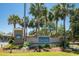 Beautiful Ocean Lakes entrance sign surrounded by palm trees and landscaped greenery under a clear blue sky at 6001-1783 S Kings Hwy., Myrtle Beach, SC 29575
