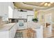 Well-equipped kitchen with white appliances, tile countertops, and a breakfast bar, perfect for casual dining at 6001-1783 S Kings Hwy., Myrtle Beach, SC 29575