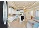 Bright, open kitchen with white cabinetry, tiled floors, and island, connecting to the living area at 6001-1783 S Kings Hwy., Myrtle Beach, SC 29575