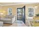 Bright living area with a view of the front deck through the glass-paneled front door at 6001-1783 S Kings Hwy., Myrtle Beach, SC 29575
