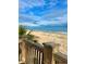 Scenic ocean view from a wooden deck with railing, showcasing the beach, calm water, and cloudy sky at 6001-1783 S Kings Hwy., Myrtle Beach, SC 29575