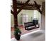 Comfortable covered porch swing with wooden beam supports at 6001-1783 S Kings Hwy., Myrtle Beach, SC 29575