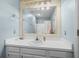 Bathroom featuring a long vanity, large mirror, and a shower with a white shower curtain at 6001-7035 S Kings Hwy., Myrtle Beach, SC 29575