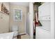 Bathroom with a washer and dryer, shower, toilet, and decorative artwork at 6001-7035 S Kings Hwy., Myrtle Beach, SC 29575